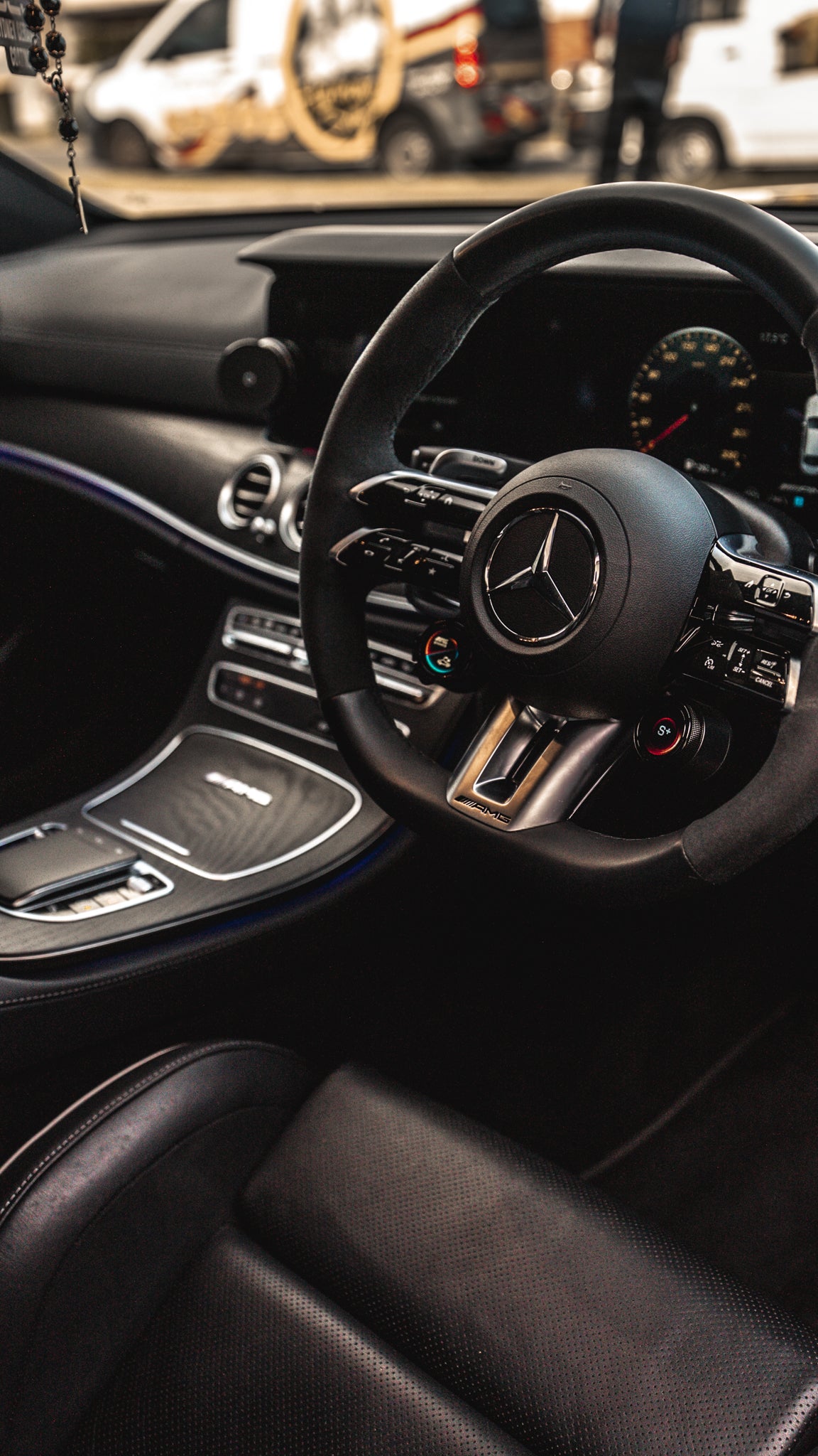 Mercedes-Benz steering wheel with dashboard in a car interior